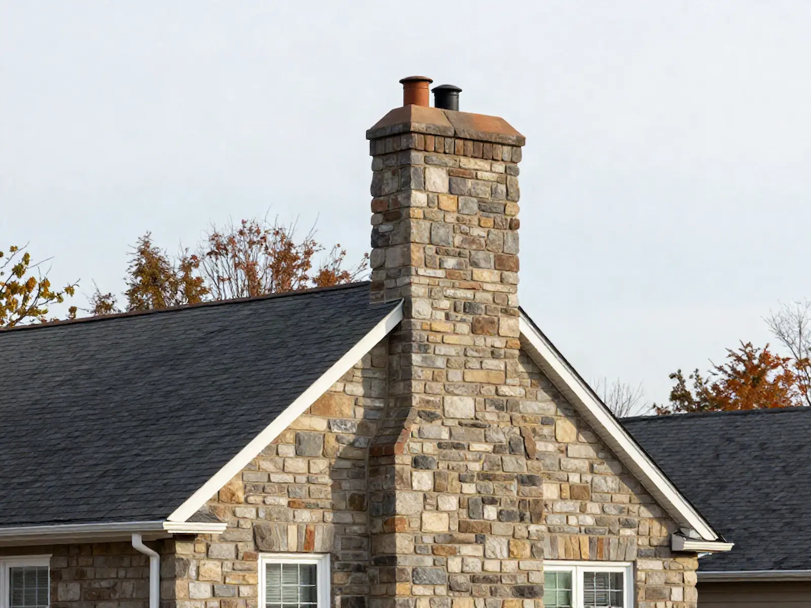 Brick chimney on a home served by Matt & Manny's Chimney Cleaning in Cromwell, CT